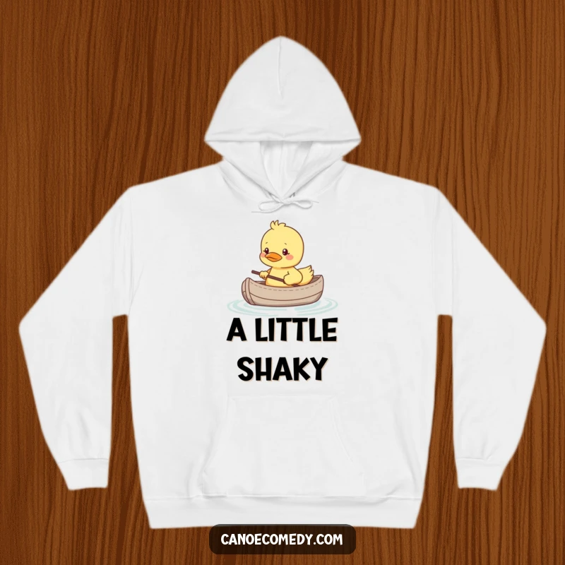 Funny hoodie featuring a shy kawaii duckling in a tiny canoe, looking nervous, perfect for cozy, humorous wear.