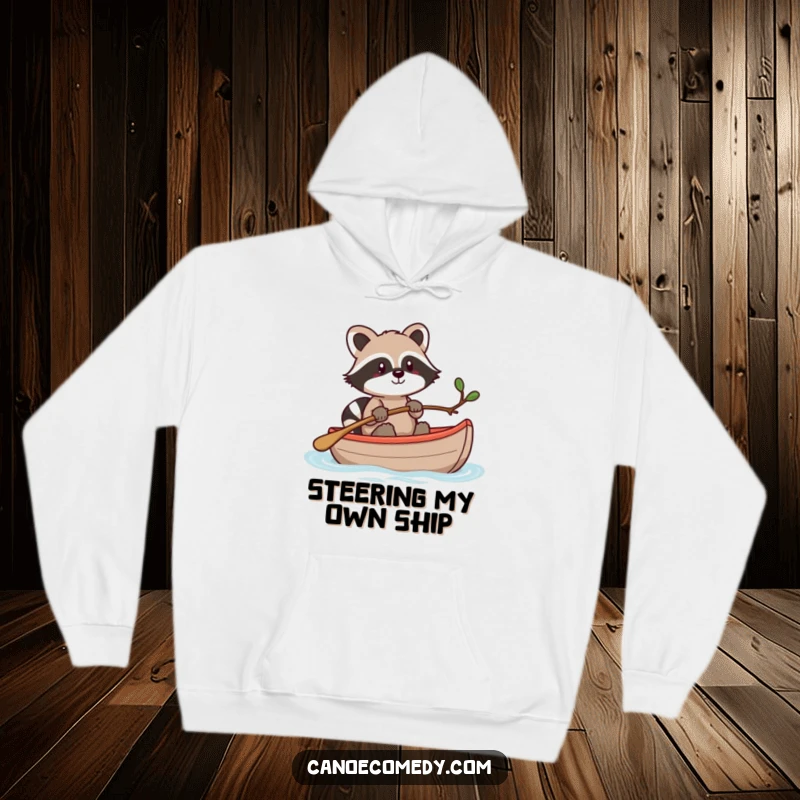 Funny Kawaii raccoon in a canoe, steering with a twig, a cozy and humorous hoodie for outdoor fans.