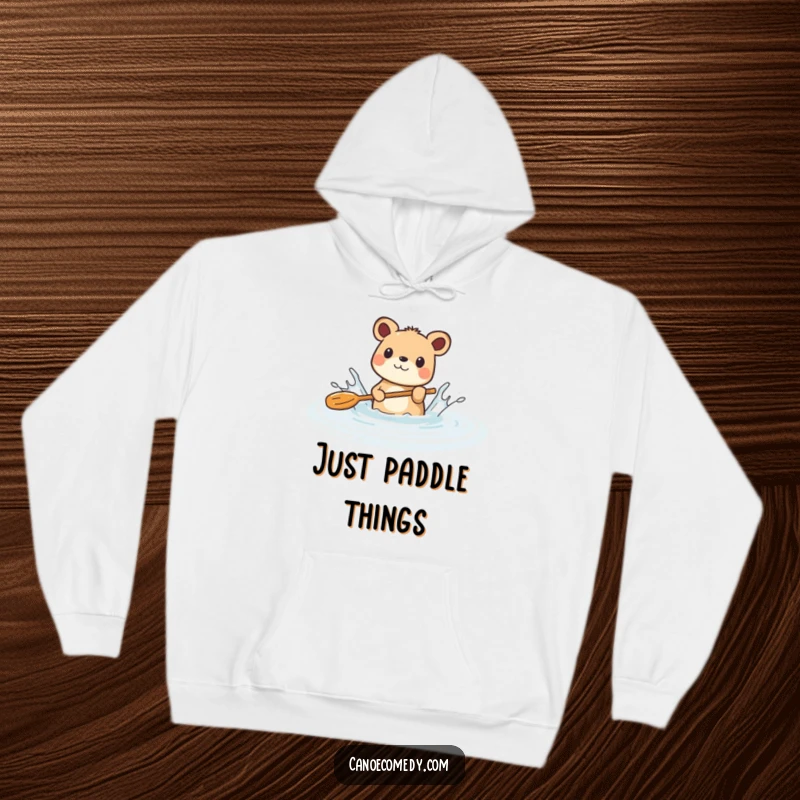 Funny hoodie depicting a cheerful animal comically splashing water with its paddle in a peaceful river, showcasing playful exuberance.