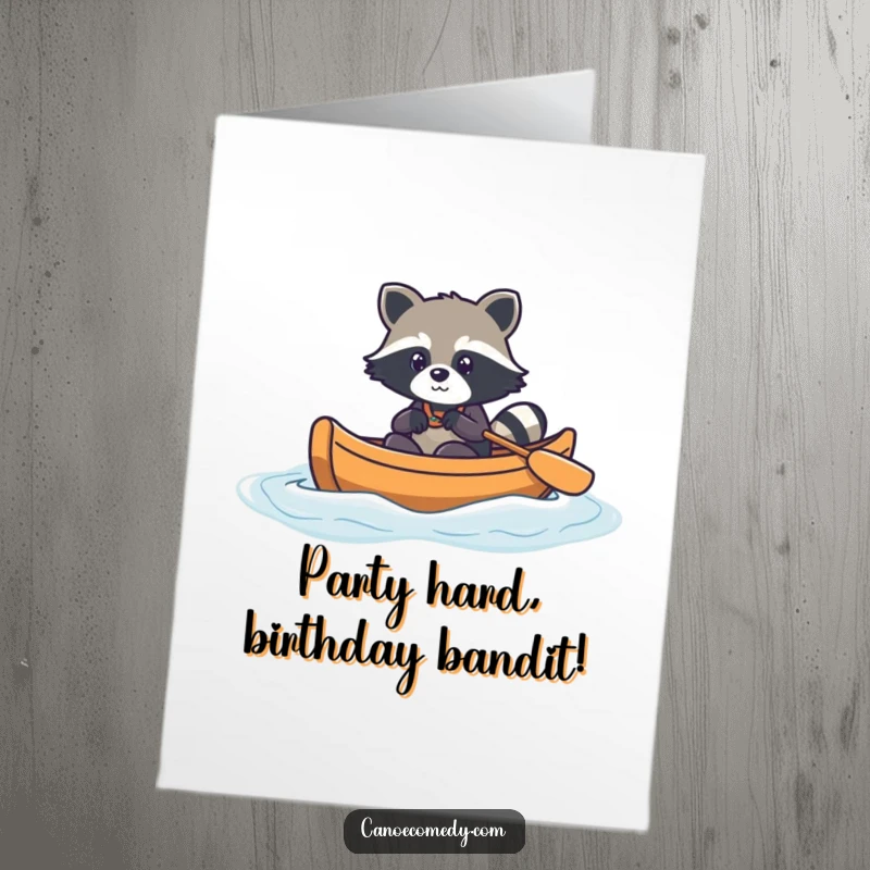 Funny Free Printable Birthday Card: Kawaii raccoon navigating canoe through gentle waves, adventurous, cute, downloadable gift.