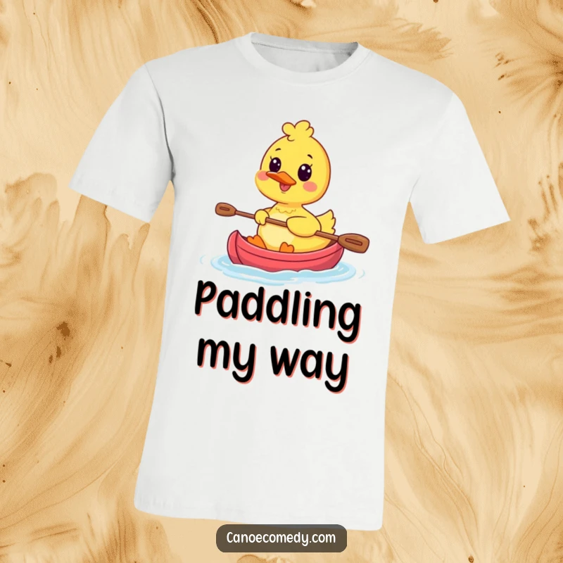 Funny Kawaii Duck Canoe T-Shirt showing a happy duck character paddling a small canoe with great enthusiasm and a wide smile.