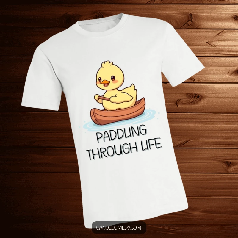 Funny, smiling Kawaii duck paddling a tiny canoe with a happy expression on a t-shirt.