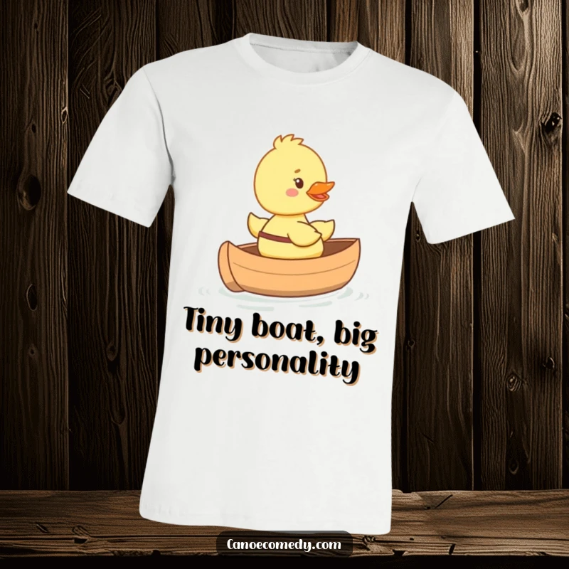 Funny happy duckling t-shirt riding in a tiny canoe with a big smile, cute and cheerful design for animal lovers.