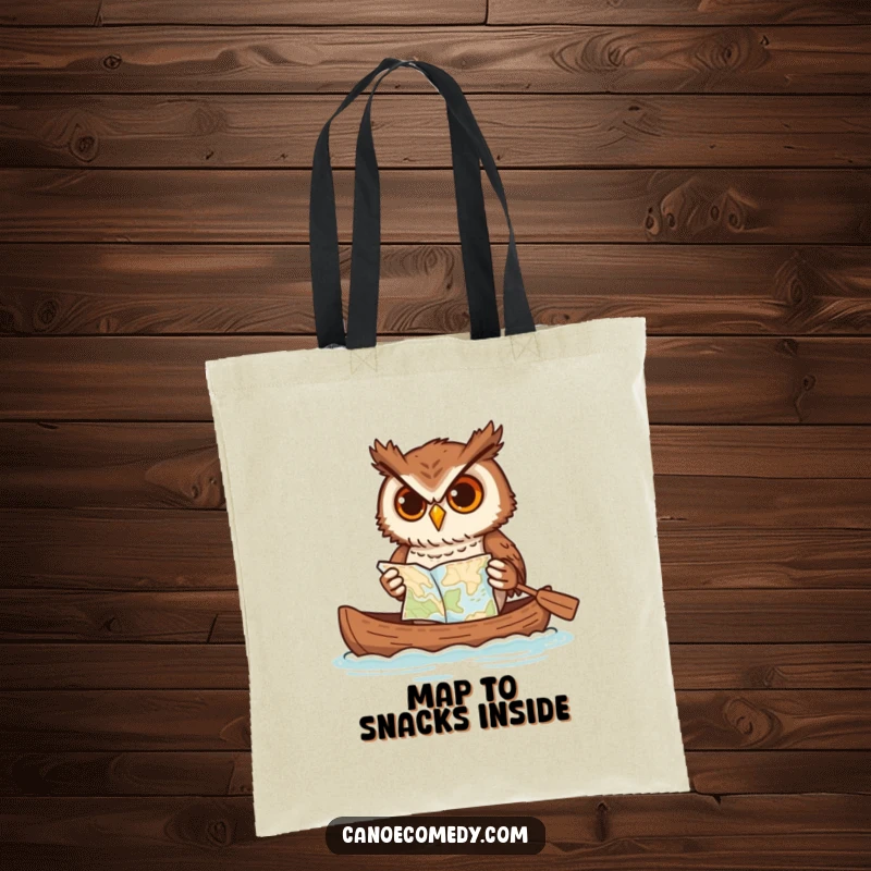Funny owl tote bag, hilariously balancing a map while paddling a canoe, showcasing a determined yet amusing adventurer.